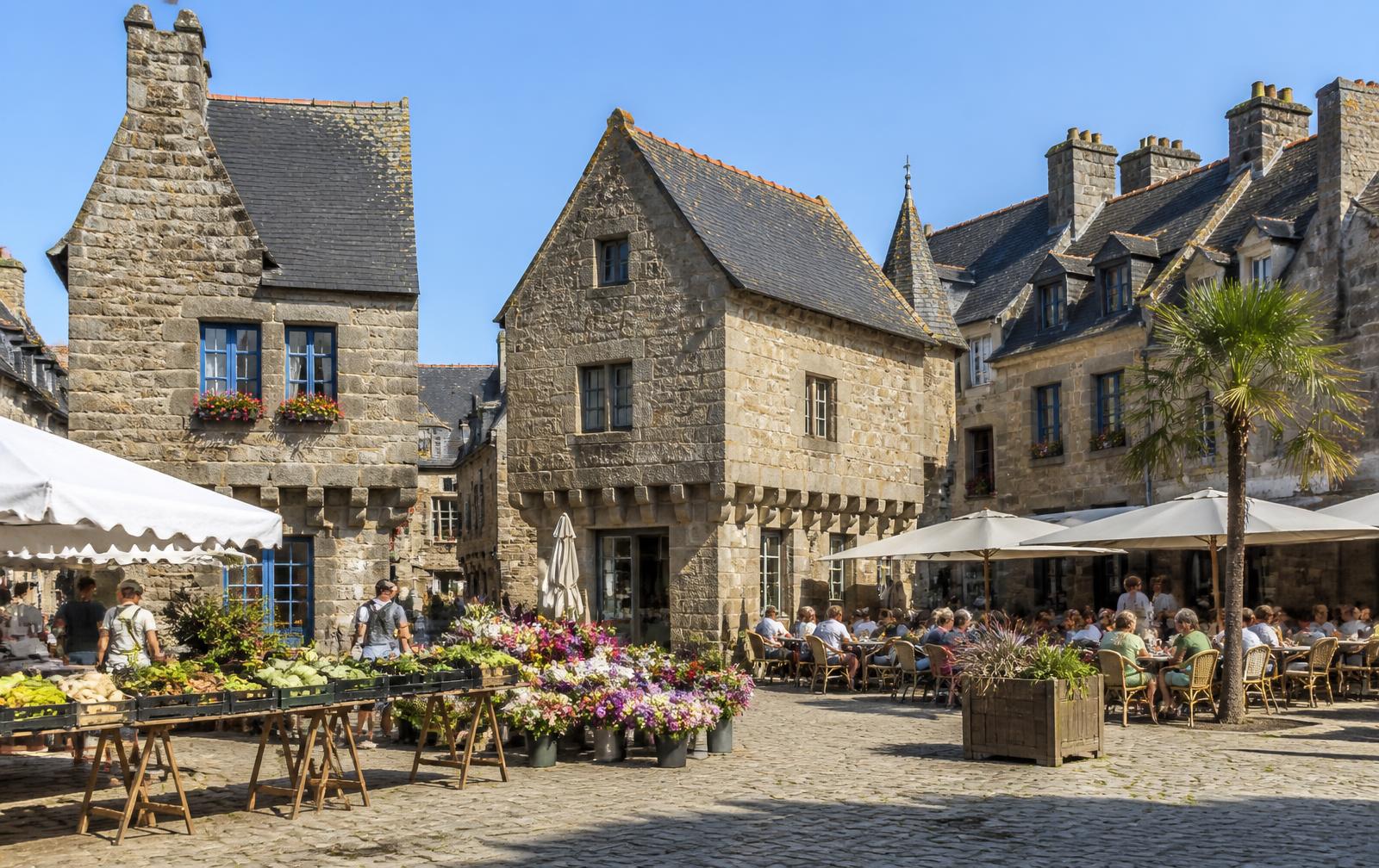 Illustration de la place du Martray à Paimpol : maisons de granit à encorbellement, étals de marché et terrasses de café